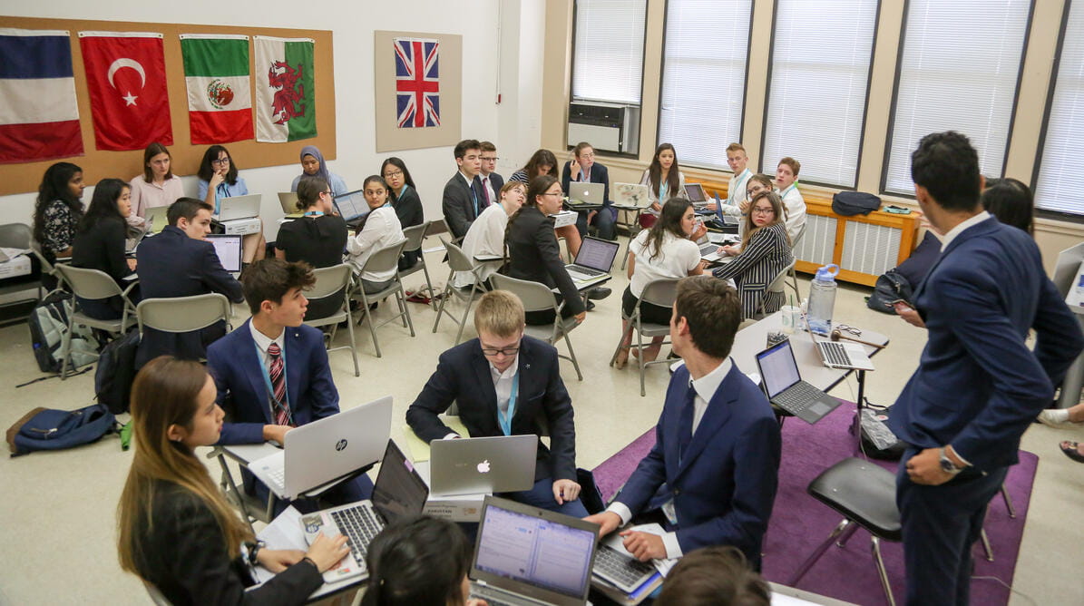 Students sitting in groups during Model UN event